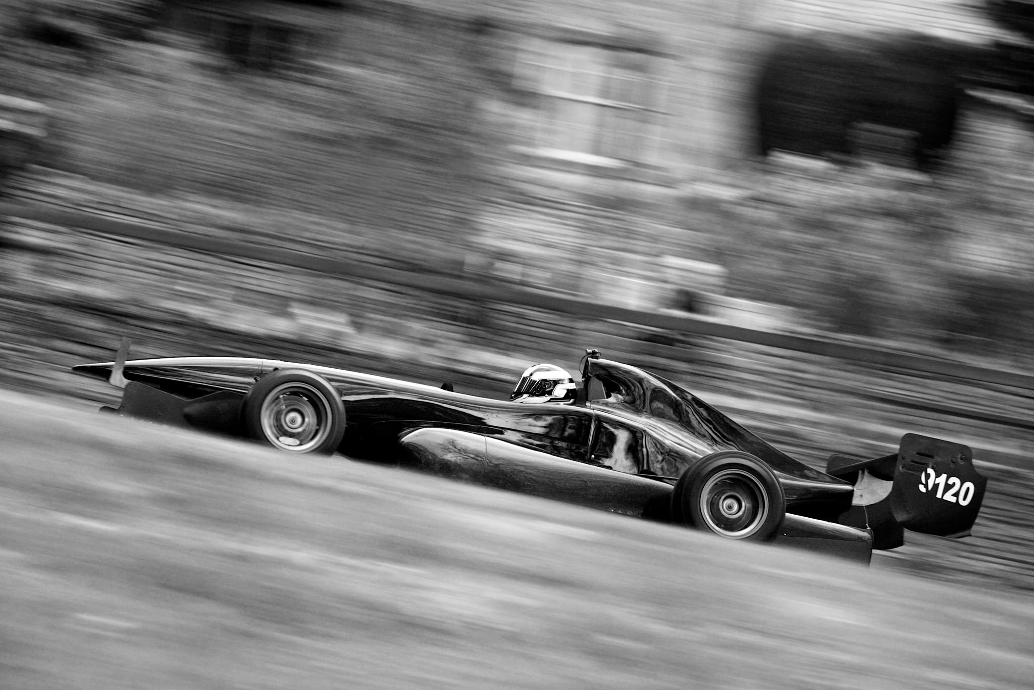 Black Empire racing car captured at speed