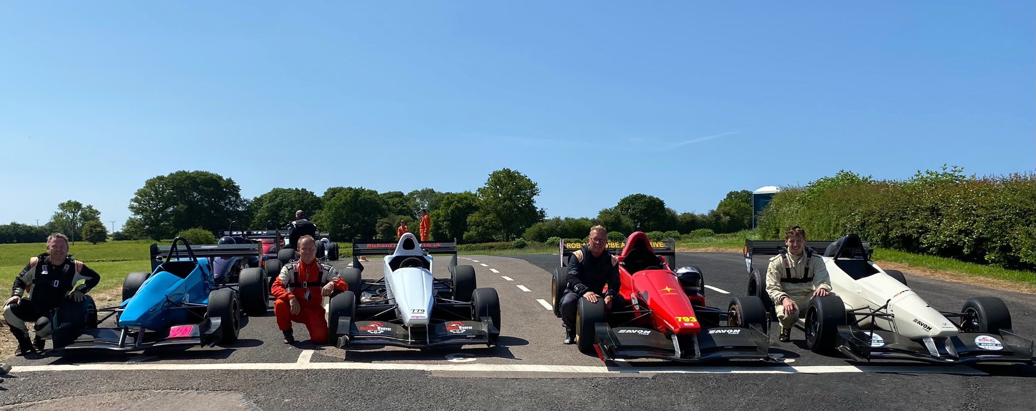 Four Empire racing cars with their drivers